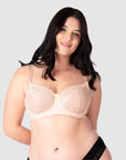 Experience complete support with Hotmilk Lingerie UK's Temptation in Powder. This acclaimed award-winning style boasts flexi underwire, a hint of sheer lace over soft cotton cups, convenient nursing clips, and elevated all-day comfort and support. Olivia confidently wears size 14/36D in this essential nursing and maternity bra