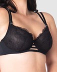 Take a closer look at the True Luxe by Hotmilk Lingerie UK in black, showcasing its contemporary twin strap detailing, semi-sheer full cup coverage, and flexi underwire support. The modern signature magnetic nursing clips and center cutouts elevate this style to the next level of sophistication. Embrace empowerment throughout your breastfeeding journey with this exquisite bra, designed to accommodate cup sizes up to J cup, without making any compromises