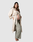 Kami showcases the versatility of Hotmilk's mix-and-match collection, featuring Hotmilk's Lounge Robe, meticulously crafted from a soft linen blend in a tranquil birch color. The robe offers a comfortable fit with elegant 3/4 length kimono-style sleeves. This set perfectly exemplifies the seamless fusion of luxury and comfort, meeting the demands of pregnancy, breastfeeding, and postpartum care
