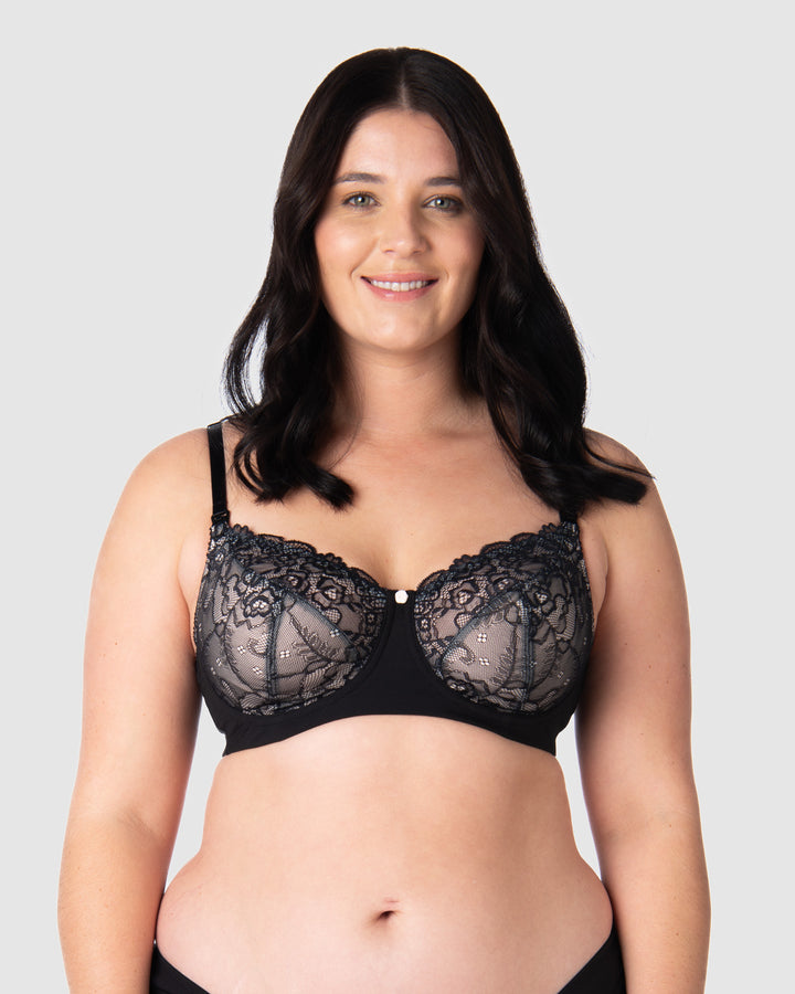 Olivia elegantly showcases Hotmilk's award-winning flexi underwire maternity and nursing bra, Temptation in Black. This versatile everyday black lace full cup bra provides ample lift and support. With fully adjustable straps, it's suitable for both date nights and all-day wear, making it an ideal choice for breastfeeding mothers