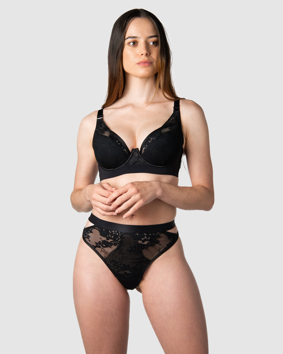 Hotmilk Lingerie's Goddess g-string forms a captivating date night ensemble, beautifully matched with the Goddess Plunge bra as modeled by Emily, a mother of 1. This set showcases edgy strap details and intricate large floral lace