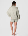 Get a glimpse of the back view of Hotmilk UKs versatile mix-and-match collection as it flawlessly combines the Lounge Top with the Lounge Short, creating the ultimate ensemble for warm days and evenings. These garments are impeccably crafted from a soft linen blend in a serene Sage color, promising a comfortable fit with elegant 3/4 length kimono-style sleeves. This set epitomizes the seamless blend of luxury and comfort, perfectly addressing the requirements of pregnancy, breastfeeding, and postpartum care