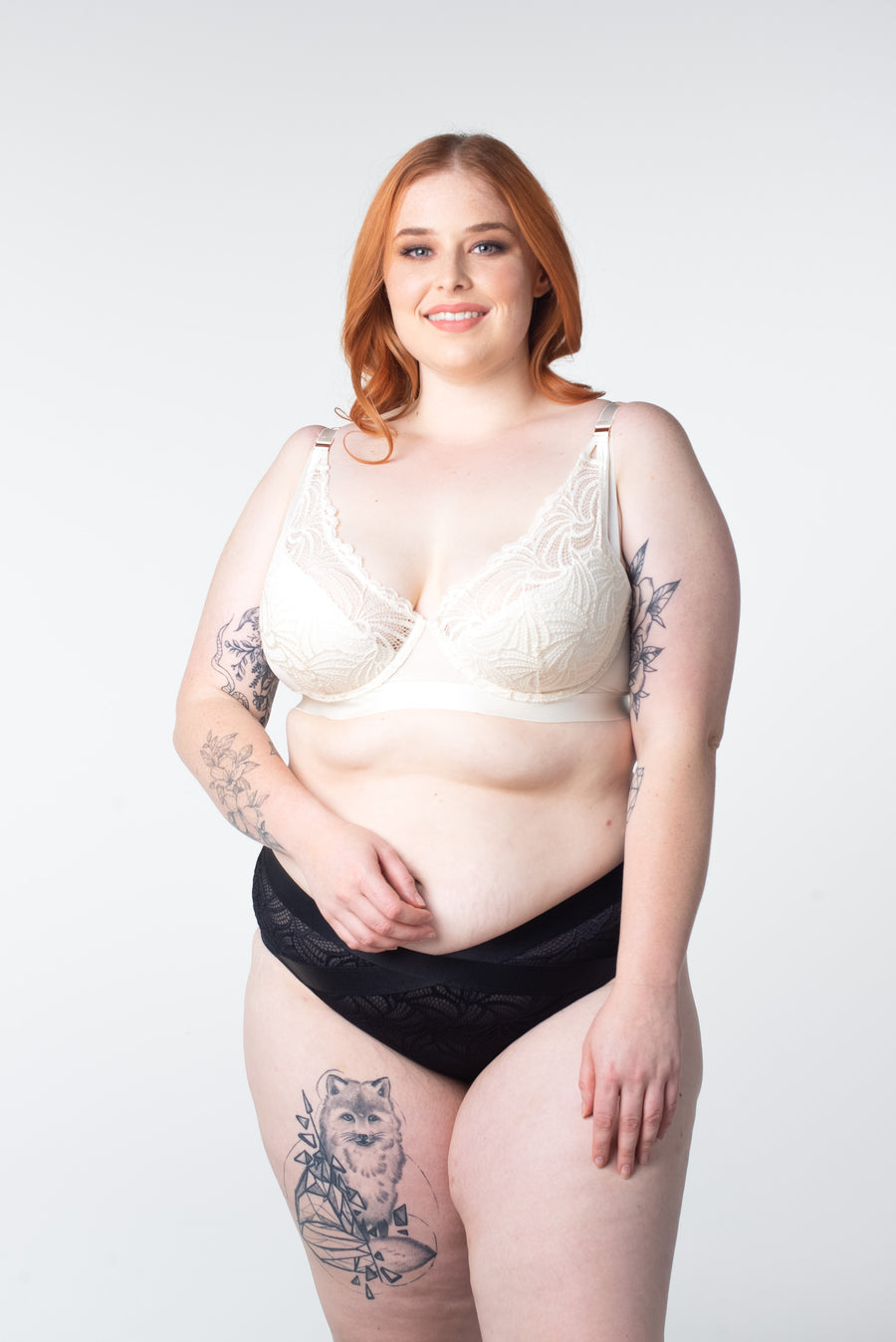 Ali, stunningly shows off the Warrior Plunge Ivory nursing and breastfeeding bra by Hotmilk Lingerie. Featuring an edgy design, graphic lace, and magnetic clips for added flair, this ensemble is elevated by the supportive features of contour cups and flexi underwire, providing both comfort and lift
